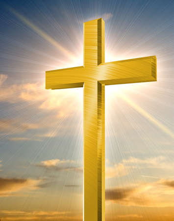 golden cross shining in front of orange sunset の写真素材