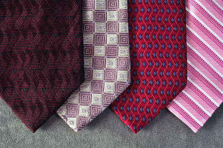 Four ties in tones of red, burgundy and pink 