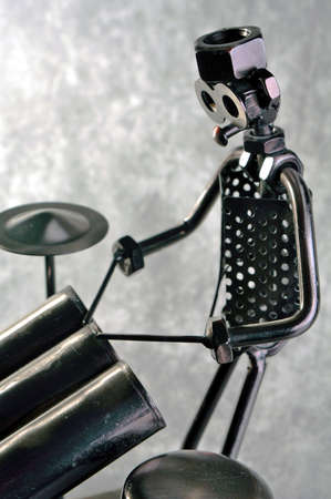 A drummer figure made from metal, steel, and iron parts, in exhibition on a gray neutral background  の写真素材