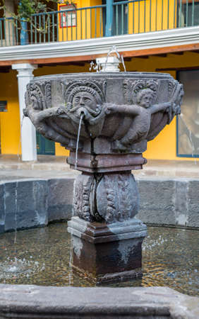 An old colonial fountain in the middle of a patioの写真素材