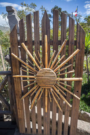 Wooden door with a sun decoration made of sugar canesの写真素材