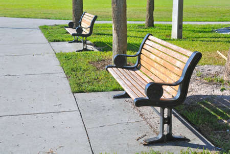 Pair of metal and wooden benches at a beach park in St  Petersburg, Florida  の写真素材