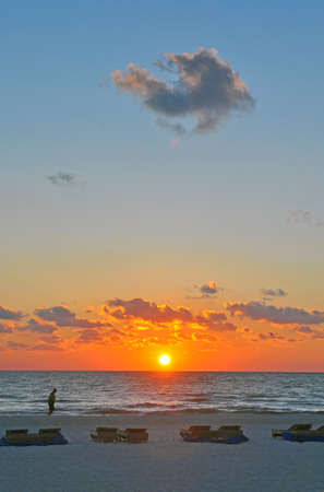 Beach Landscape moments before sunset with folded up beach chairs in the foreground  St  Pete, Florida  の写真素材