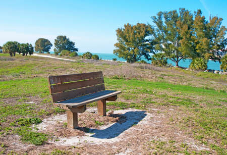 A wooden bench close to the ocean, at Bellair Beach, FL  の写真素材