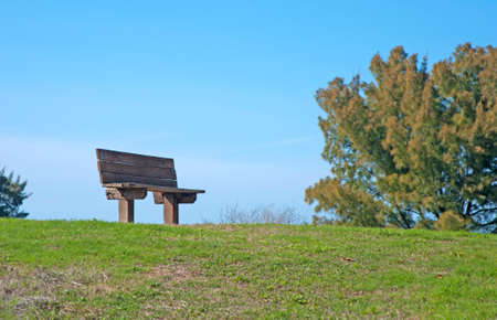 A wooden bench at the top of a hill, at Bellair Beach, FL の写真素材