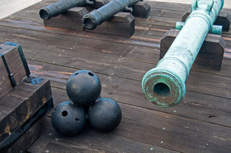 Old canons and cannonballs in a fort, on an overcast day. Old Castillo de San Marcos, St. Augustine, Floridaのeditorial素材