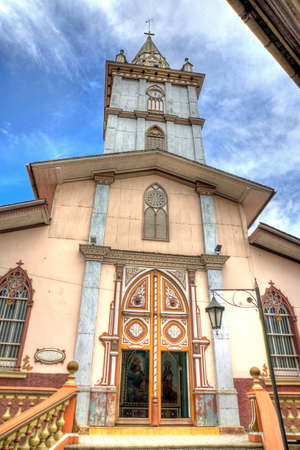 Facade and steeple of an old cathedral, Zaruma, El Oro, Ecuador on an overcast morning.のeditorial素材