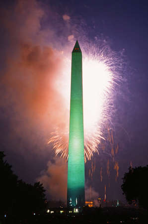Bright lights from fireworks light up the sky with the Washington Monument in the foreground on the 4th of July celebration. Washington DC., USAのeditorial素材