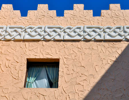 An Arabic designed building, with a window, on a sunny morning with a dark blue sky. Tampa, Florida, USA.の写真素材