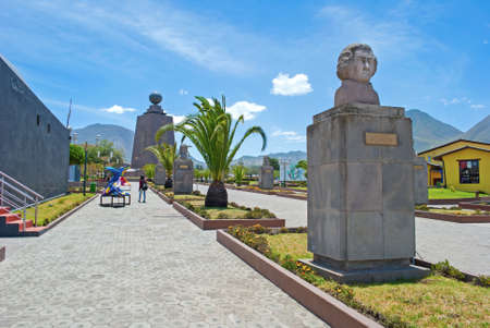 Walkway to the main monument at the Middle of the World touristic park, with palm trees and busts of national heroes on the way. Sunny summer morning. Ecuador.のeditorial素材