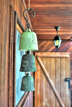 Bell ornaments hanging from the ceiling at an old jungle house, in Ecuadorの写真素材