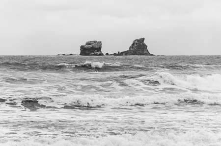 Two rock island formations in the middle of the ocean, in front of the town of Ayampe, Manabi, on an...