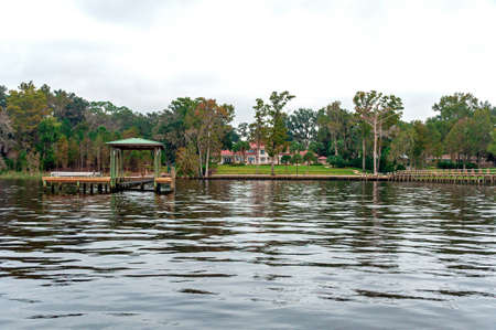 Beautiful Floridian houses with wooden docks on the river. Jacksonville, Florida, USAの写真素材
