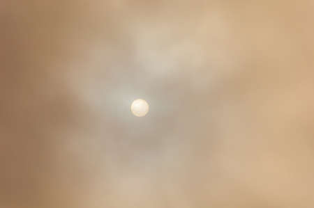 View of the sun through clouds and fog, on an overcast morning. Jacksonville, Florida, USA.