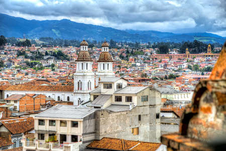 View of the city of Cuenca, with it's many churches, cathedrals and houses, in the middle of the Ecuadorian Andes, on a sunny afternoon, Ecuador, South America.の写真素材