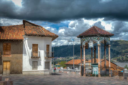 Cuenca, Ecuador, November 2013: Beautiful gazebo and colonial house,  which are part of the Ford Square (Plazoleta del Vado), on a cloudy afternoon.のeditorial素材