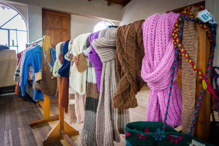 Guaranda, Bolivar Province, Ecuador - November 2013: Wool clothing items in display and for sale, recently manufactured, in a small humble local shop.のeditorial素材