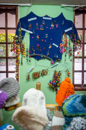 Guaranda, Bolivar, Ecuador - November, 2013: Inside a local shop, with many wool products, such as hats and sweaters. Also for sale are earrings, pendents, necklaces and other imitation jewelry.のeditorial素材