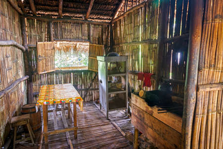 Guayaquil, Guayas, Ecuador - November, 2013: Replica of the interior of an old jungle hut, made from wood and straw, at the Parque Nacional (National Park).のeditorial素材