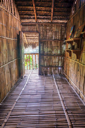 Guayaquil, Guayas, Ecuador - November, 2013: Replica of the interior of an old jungle hut, made from wood and straw, at the Parque Nacional (National Park).のeditorial素材