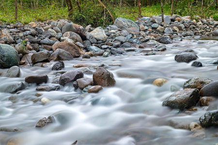 Long exposure of a portion of a river that crosses the town of Mindo, Pichincha Province, Ecuador; on an overcast and cloudy afternoon.の写真素材