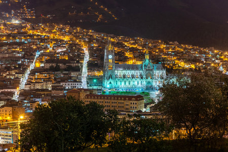 Basilica church in Quito, at night, fully illuminated, from across townの写真素材
