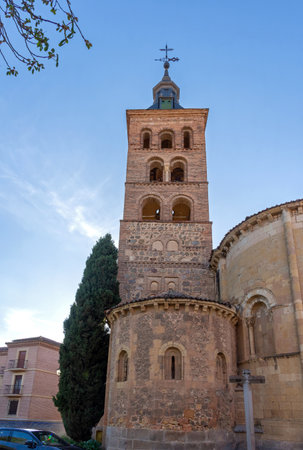 The historic Romanesque tower and apse of the Church of San Juan de los Caballeros in Segovia. Built of stone and brick, this 12th-century structure rises beneath a clear skyの写真素材