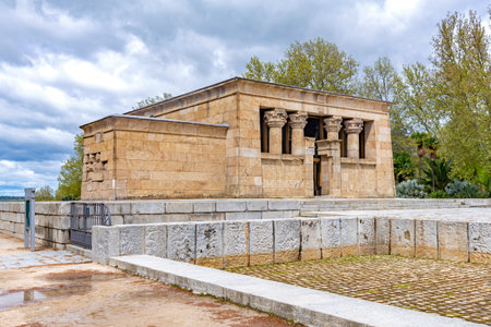 The Temple of Debod in Madrid, an ancient Egyptian monument, shows two weathered stone pylons and...