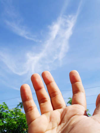 hand and skyの写真素材