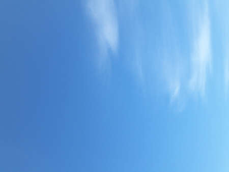 Blue sky background with cloudsの写真素材
