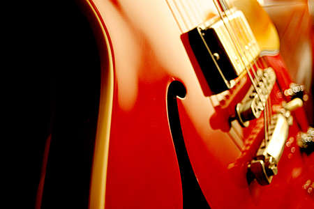 Closeup of a red hollow body jazz guitar