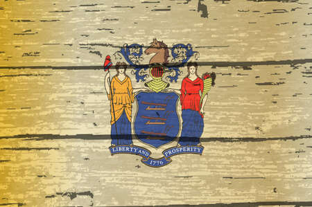 The flag of the USA state of New Jersey on a wooden backgroundの写真素材