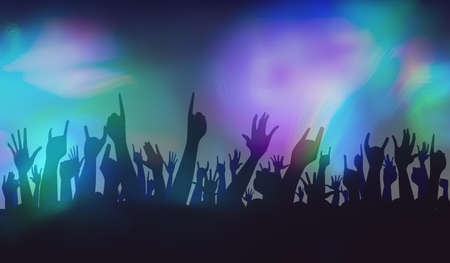 Hands raised in the air at a concert with bright lightsの写真素材