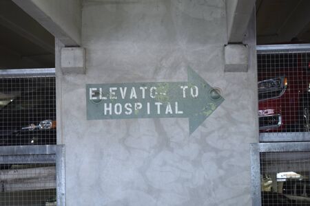 Elevator To Hospital Large Green Arrow Vintage Worn Painted Signの写真素材