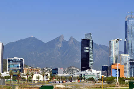 Blue Building of Monterrey Mexico City with Cerro de la silla de fondo de dayのeditorial素材