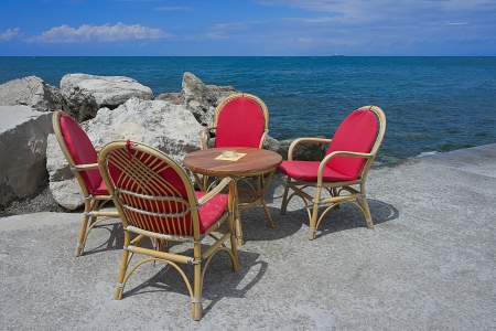 Table and chairs on the shore of the Adriatic Seaの写真素材