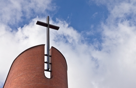 Cross of Evangelical Church against the sky with clouds
