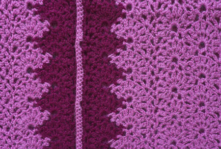 Openwork knitted fabric made of pink yarn with dark inset  Crochet knitting の写真素材
