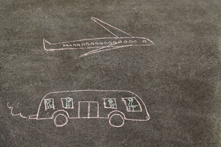 Children's drawing of bus and plane made chalk on the pavingの写真素材