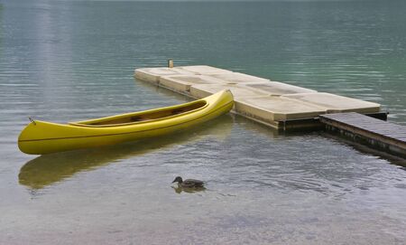 Boat canoe is on the pier near the lakeの写真素材