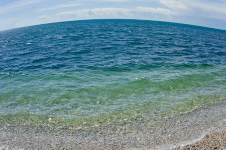 Sea and pebble beach. Fish eyeの写真素材