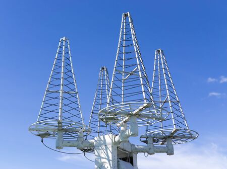 Three satellite antennas on background blue sky