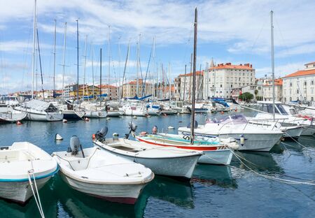 Boats parking near quay of old townの写真素材