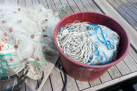 Fishing nets and fishing tackle are on wooden pierの写真素材
