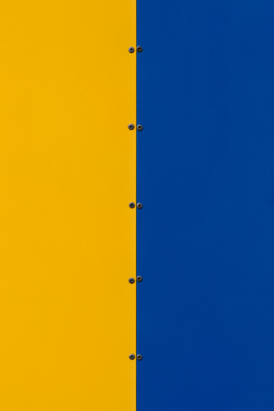 Texture metal plates of yellow and blue color connected rivets