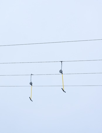 Empty ski lifts against background of overcast sky