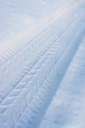 Tracks car tyre in snow.Small depth of field