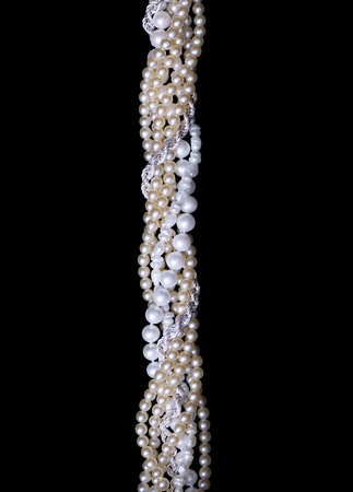 Twisted strings of river and sea pearl isolated on black backgroundの写真素材