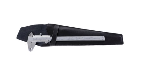 Vernier caliper is on black leather cover isolated on white backgroundの写真素材