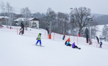 MOSCOW, RUSSIA - JANUARY 25, 2015: Ski club Leonid Tyagachev-oldest ski resort in Moscow region and training base for Russian national teams.Boy to roll downhill on slope on snowboardのeditorial素材